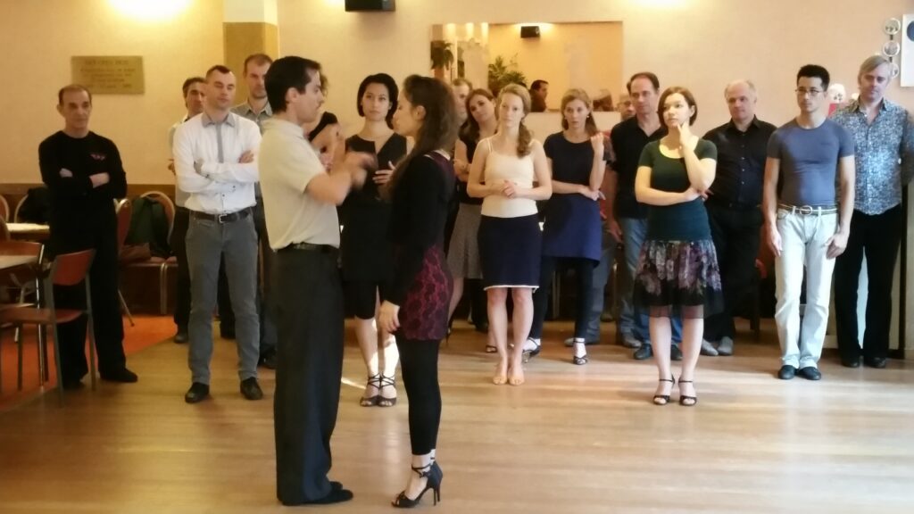 Tango teacher demonstrating connection and communication during a corporate workshop